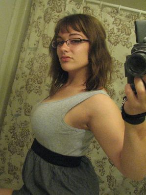 A girl with large breasts poses in clothes and then undresses. Part 2. Thumbnail 15