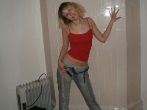 A blonde with a thin waist poses in glasses and red panties. Part 2. Thumbnail 6