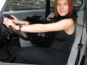 A redhead girl in fishnet tights undresses right on the street. Thumbnail 8